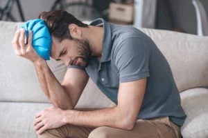 man with ice pack on head