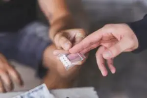 person handing pills to another person