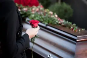 woman with a rose for a casket
