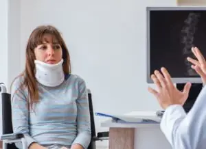 woman with neck injury talking to her doctor