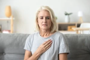 A woman holds her chest