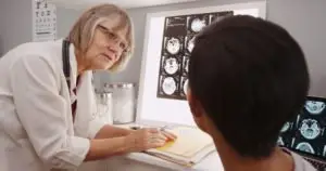 doctor discusses brain injury with patient
