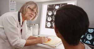 doctor discusses brain injury with patient