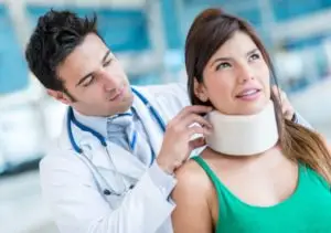 doctor fits a patient for a neck brace