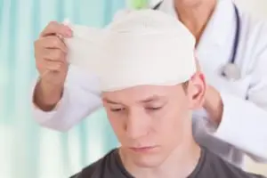 doctor treats a patient with a head injury
