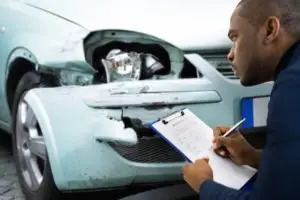 insurance agent starts paperwork after a car crash