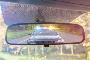 police car in the rear view mirror