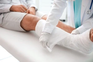 doctor treats patient with broken leg