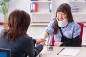 injured woman consults with attorney