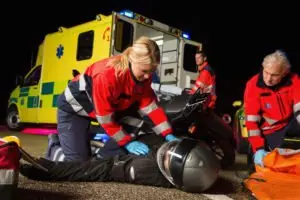 paramedics assist motorists after motorcycle crash