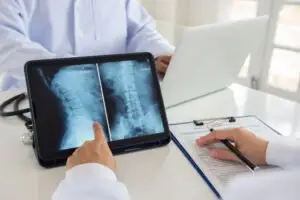 spine doctor reviews a patient file