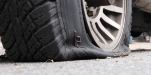 A truck with a burst tire.