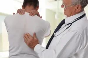 man visits doctor for back pain