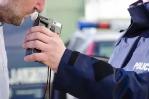 driver taking a breathalyzer test
