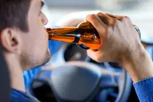 man driving while drinking