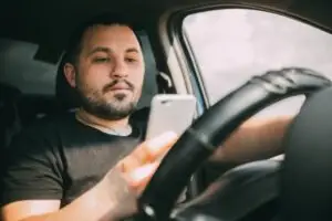 man-texting-while-driving