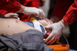 Paramedics treating a person after car accident