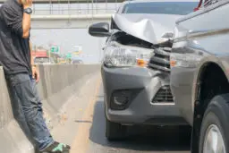 Man standing next a car after car acciddent