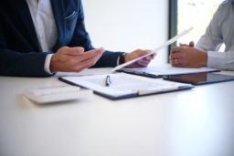 an insurance agent and a lawyer settling a car accident claim