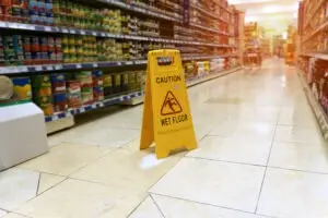 yellow caution sign for slip and fall in sacramento grocery store