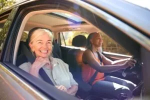 rideshare driver smiling with passenger