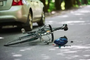 bicycle and helmet on road after crash