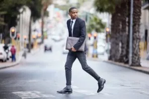 black man crossing a city street