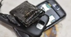 A mobile phone with a melted battery that caught on fire