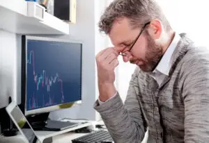 stressed man after becoming victim of investment fraud