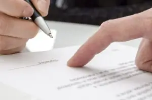 Person signs paper to allow lawyer to collect crucial evidence for a motorcycle accident case.