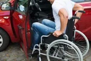 A man in a wheelchair getting into a car. You can discuss your legal situation with a North Fort Myers catastrophic injury lawyer.