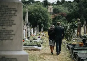 A couple walks in a cemetery. A wrongful death lawsuit attorney can help Bonita Springs, FL, parties sue for losses in a negligence accident.