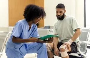 A nurse talks with an injured patient. A catastrophic accident lawyer in Marco Island, FL, can help victims recover compensation for their injuries.