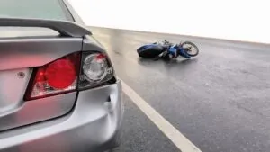 A car and motorcycle after a crash. A lawyer can explain what happens if the at-fault driver in a motorcycle accident doesn’t have insurance.