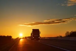 large-truck-driving-at-sunset