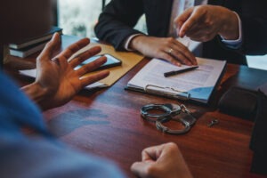 person-being-questioned-by-police-with-handcuffs-on-desk