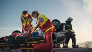 a-car-accident-victim-being-treated-for-a-catastrophic-injury-at-the-scene-of-a-crash