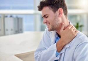 man-grabs-neck-in-pain