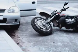 motorcycle-lying-on-road-car-standing