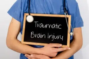 Nurse-holding-traumatic-brain-injury-sign-East-Lansing