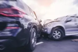 A car accident lawyer helps an injured victim after a two-vehicle crash.