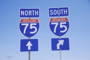 Two signs for the dangerous Interstate 75 in Michigan. If you were involved in a crash, a car accident lawyer will help you file a claim.