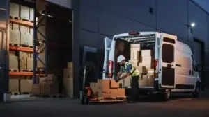 Michigan delivery truck driver unloads boxes from truck