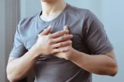 A man feeling pain in his chest. If you’re experiencing chest pain after a motorcycle accident, make sure you seek medical care.