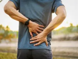 A man experiencing back pain. Go over your options if you’re suffering from back pain after a motorcycle accident.