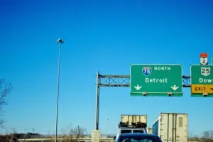 Michigan highway with traffic jam and Detroit sign