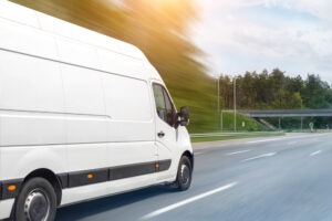 white delivery truck speeds on highway in michigan