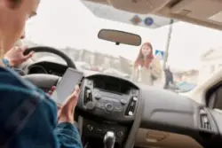 texting driver approaching pedestrian