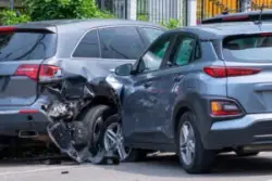 two grey cars in a crash