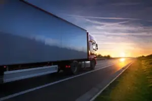truck driving on the road at sunset